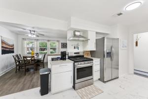 a kitchen with a stove and a refrigerator at Boho Bungalow near DFW Airport in Farmers Branch