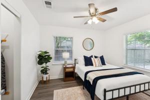 a bedroom with two beds and a ceiling fan at Boho Bungalow near DFW Airport in Farmers Branch