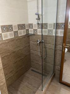 a bathroom with a shower with a glass door at Hotel Prestige Beach in Costinesti