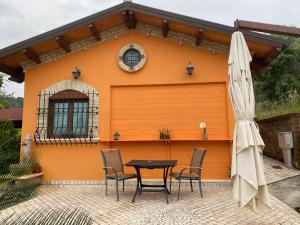 a table and chairs in front of a house at Dependance con vista mare in Colonnella
