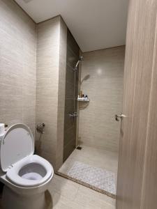 a bathroom with a toilet and a shower at Moon Homestay 1717 in Gia Lâm Pho +83 photos