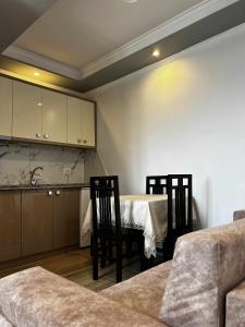 a kitchen with a table and chairs in a room at Apartments panoramic Ana in Sarandë