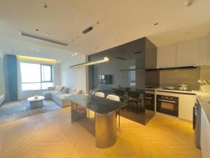 a kitchen and living room with a table and a couch at ZHome-Count luxury apartment in Shanghai