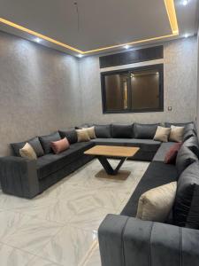 a living room with a couch and a table at حاضرة محيط in Jerifat