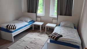 a small room with two beds and a window at Crew Quartier ALL-INCLUSIVE Apartments in Merseburg-Leuna in Merseburg
