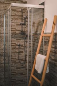 a shower in a bathroom with a glass door at CLavi Apartament in Sassari +20 photos