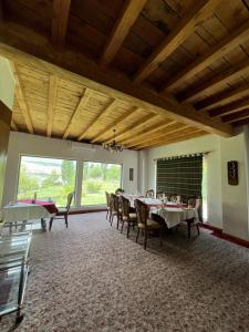 a dining room with tables and chairs and a large window at Hotel - Restaurant Siren in Khorog