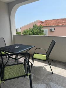 a patio with a table and chairs on a balcony at Apartment Vodice - Lovric in Vodice