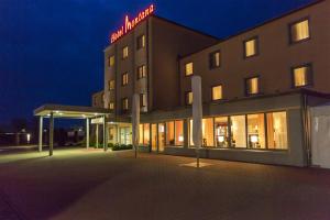 a hotel with a lit up sign on top of it at Montana-Hotel Ellwangen in Ellwangen