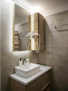 a bathroom with a sink and a mirror at DeltaLux apartmani Milmari Kopaonik in Kopaonik +38 photos