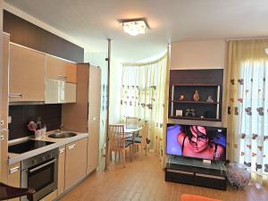 a kitchen with a flat screen tv in a room at Casa sul Mare in Vlorë +13 photos