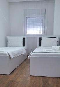 Postel nebo postele na pokoji v ubytování S-Apartmani Cocetova