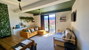 a living room with a couch and a table at The Gallery - Bournemouth Town Centre - Beach 5 Minute Walk - Superfast WiFi - Outdoor Terrace - Sleeps 6 - Netflix - Contractor Friendly - Long Stay Rates - Coffee Machine in Bournemouth