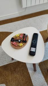 a remote control sitting on top of a white table at CMG Studio 3 Petit Bois Place Ducale in Charleville-Mézières