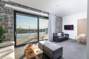 a living room with a couch and a table at Vista Komos Villa 2, New Villa with Private Pool in Pitsidia