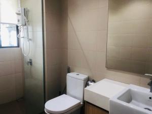 a bathroom with a toilet and a sink and a shower at Vintage Homes at i-City - WiFi TV Box 1 Carpark in Shah Alam