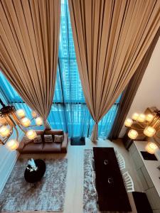 a living room with a couch and a large window at Vogue Homes at i-City - WiFi TV Box & 1 Carpark in Shah Alam