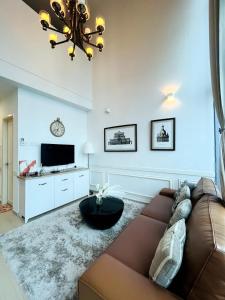 a living room with a couch and a tv at Vogue Homes at i-City - WiFi TV Box & 1 Carpark in Shah Alam