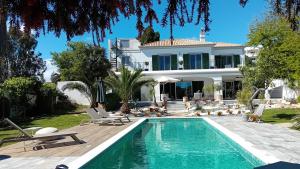 a villa with a swimming pool and a house at Luxury Casa Madeira, HEATED Salt Water Pool and Panoramic Woodfire Sauna in Lagos