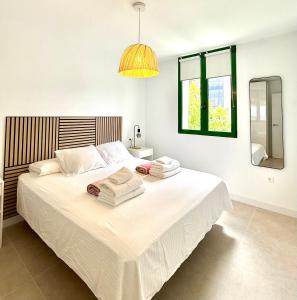 a bedroom with a large bed with towels on it at Casa Pablo in Arona +28 photos
