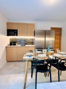 a kitchen with a table with chairs and a refrigerator at Suite Menton - Coliving, Parking & Breakfast in Cagnes-sur-Mer +6 photos