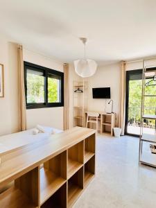 a large living room with a large wooden table at Suite Menton - Coliving, Parking & Breakfast in Cagnes-sur-Mer