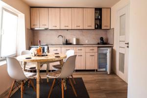 a kitchen with a table and chairs in a room at Galata Relax in Varna City