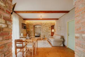 a living room with a brick wall and a table and chairs at Statek Pazderna in Pazderna