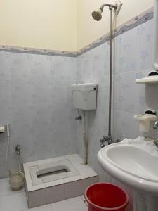 a bathroom with a sink and a toilet in it at Budget Rooms with Garden by Galiyat Inn Balakot in Bālākot