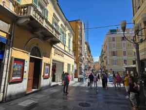 a group of people walking down a city street at HomeHolidaySanremo - Luxe & Glamour in Sanremo