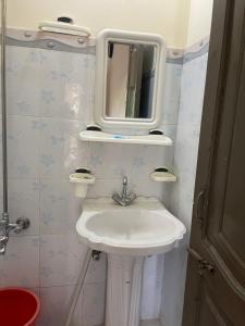 a bathroom with a sink and a mirror on the wall at Budget Rooms with Garden by Galiyat Inn Balakot in Bālākot