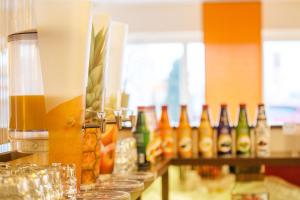 a bar with bottles of alcohol on a counter at Montana-Hotel Ellwangen in Ellwangen