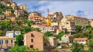 a town on a hill with houses and buildings at Résidence Arborea C3 Corte in Corte