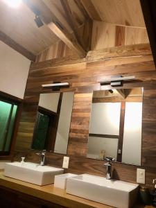 a bathroom with two sinks and two mirrors at Kumano Winery Guest House in Tanabe +59 photos
