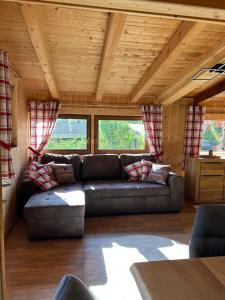 a living room with a couch and some windows at Zillertalerhütte in Aschau