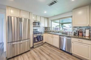 a kitchen with white cabinets and stainless steel appliances at vegas saltwater, a luxury pool villa with 5BR, Spa, wet deck on a half acre lot in Las Vegas