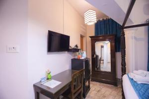 TV a/nebo společenská místnost v ubytování Le Clarisse Guest House