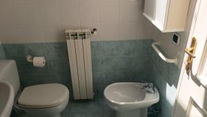 a small bathroom with a toilet and a sink at Fratti Central Beach Rooms in Viareggio +34 photos
