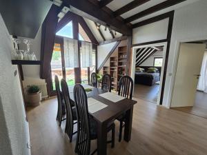 a dining table and chairs in a living room at Bahnhofsnest in Idar-Oberstein