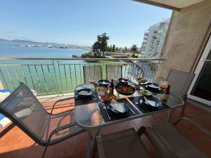 a table with food on top of a balcony at Adefer Isamar in Sanxenxo