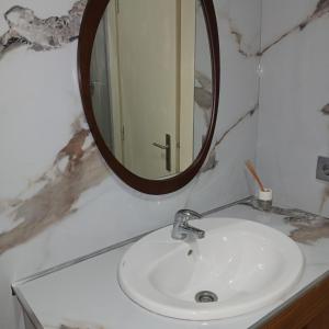 a bathroom with a sink and a mirror at Villa Regio Studio Kitchen & Garden in Vila do Conde