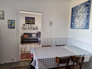a room with a table and chairs and a living room at Rodinný dům Luby in Cheb
