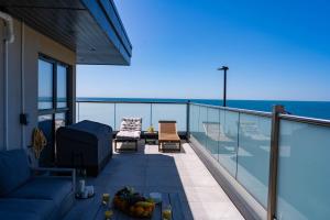 a balcony with a view of the ocean at Wight Stone Luxury Townhouse - Breathtaking Views in Sandown