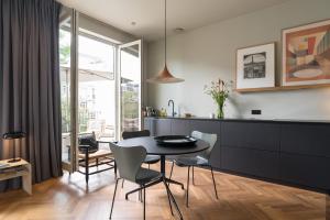 a kitchen and dining room with a table and chairs at Vondel 99 in Amsterdam
