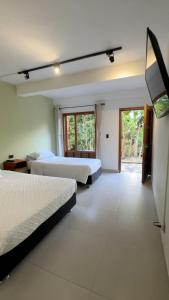 a hotel room with two beds and a television at Hotel Boutique Albania in Otanche +31 photos