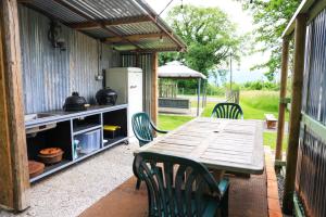 a table and chairs on a patio with a kitchen at Tiny House at Villa Ariola in Irola