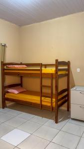two bunk beds in a room with a counter at Pousada e Hostel Refúgio dos Lençóis in Barreirinhas