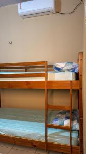 a bunk bed room with two bunk beds and a fan at Pousada e Hostel Refúgio dos Lençóis in Barreirinhas