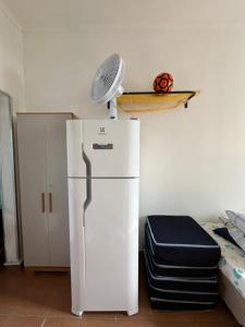 a white refrigerator with a fan on top of it at Apartamento São Vicente in São Vicente +4 photos