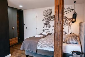 a bedroom with a bed with a camera on the wall at Penzion Na Červeném Potoce in Králíky